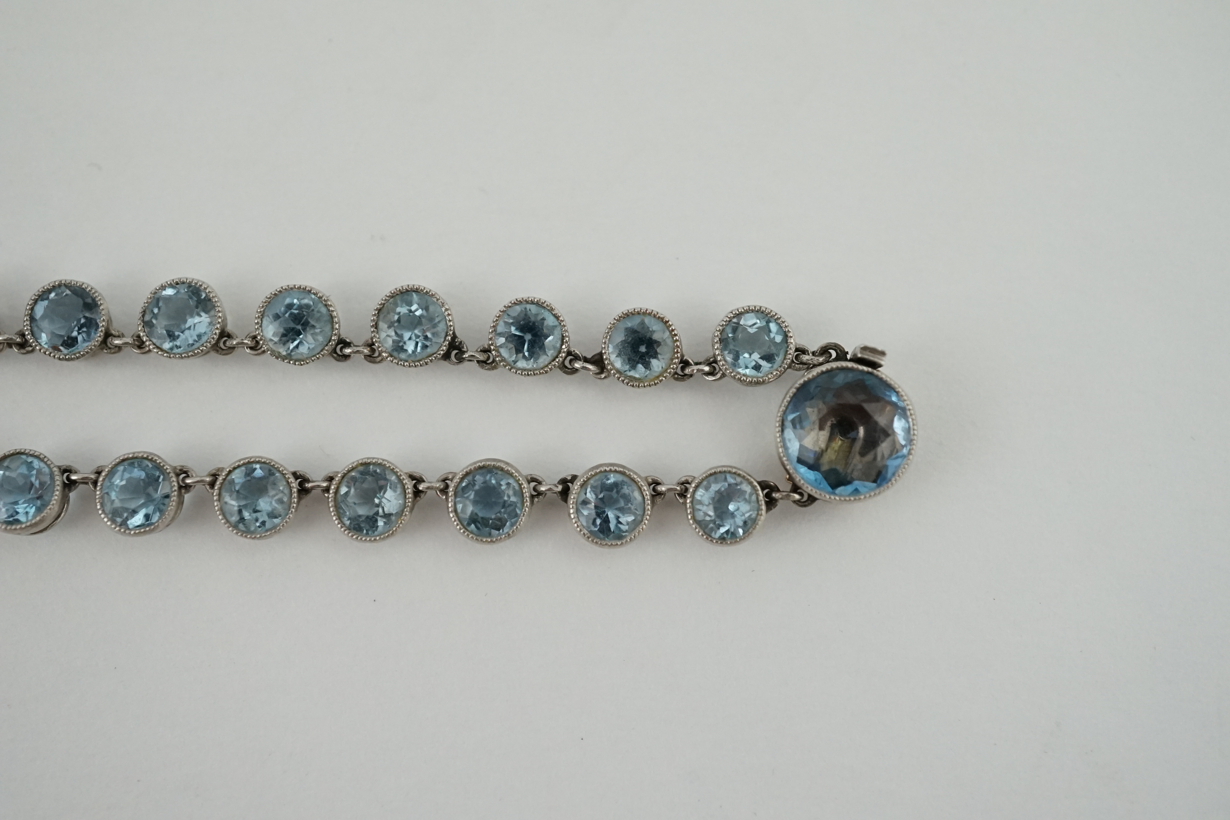 A Belle Epoque platinum and millegrain set graduated aquamarine necklace